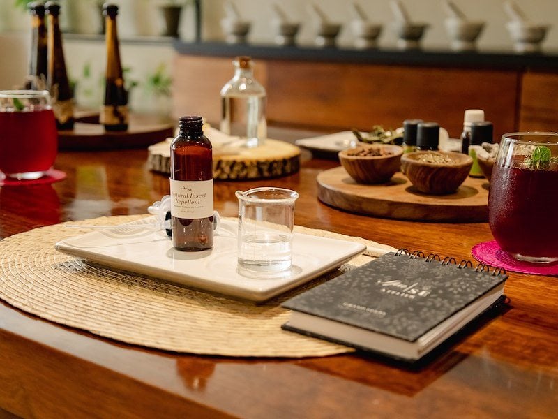 A table with a book and a bottle of liquid on it