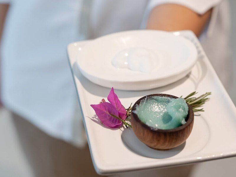 A plate with a bowl of blue gel on it
