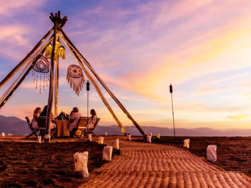 A group of people sitting under a tent