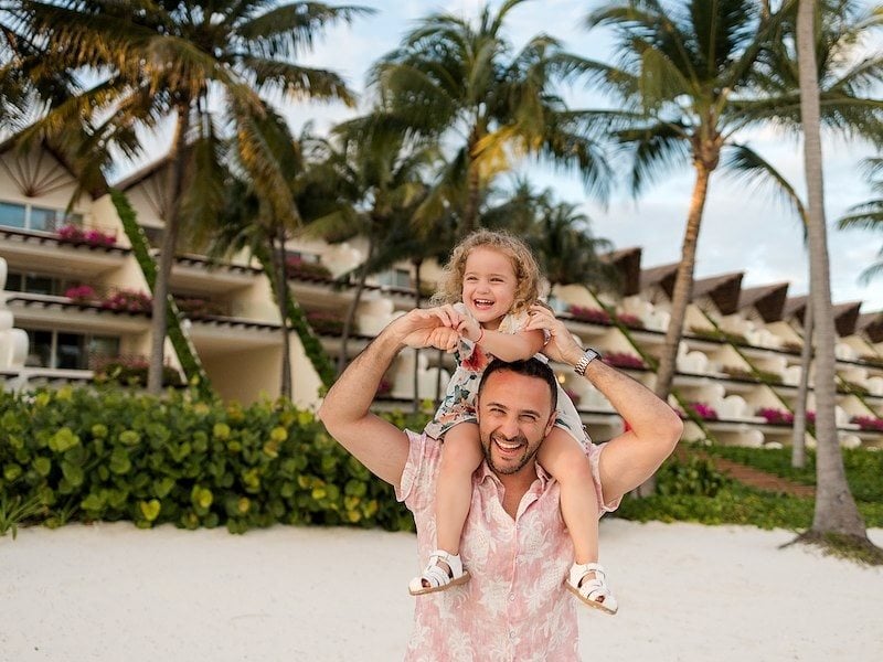 Family enjoying a beach vacation at a tropical oceanfront resort