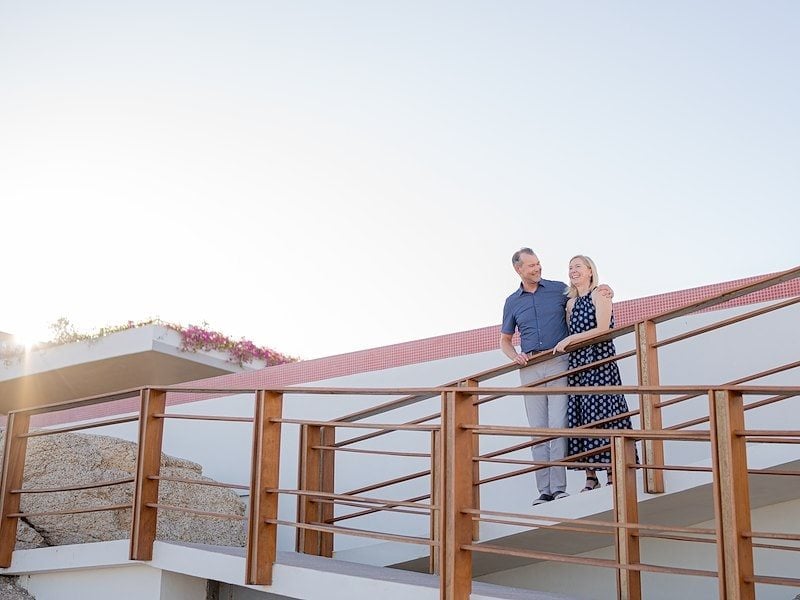 A man and woman relaxing together on a resort balcony