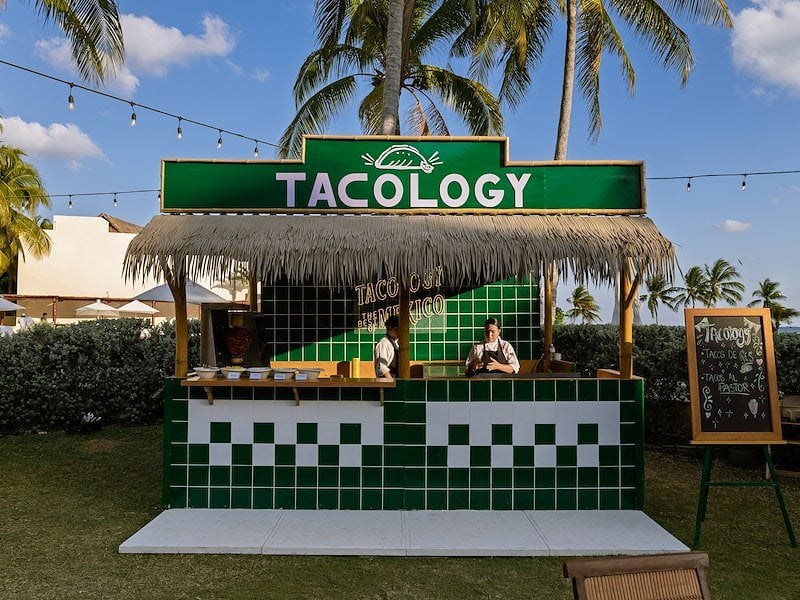 A man standing at a taco stand