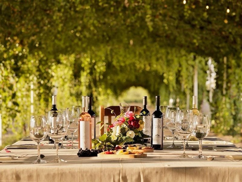 A table with wine bottles and glasses