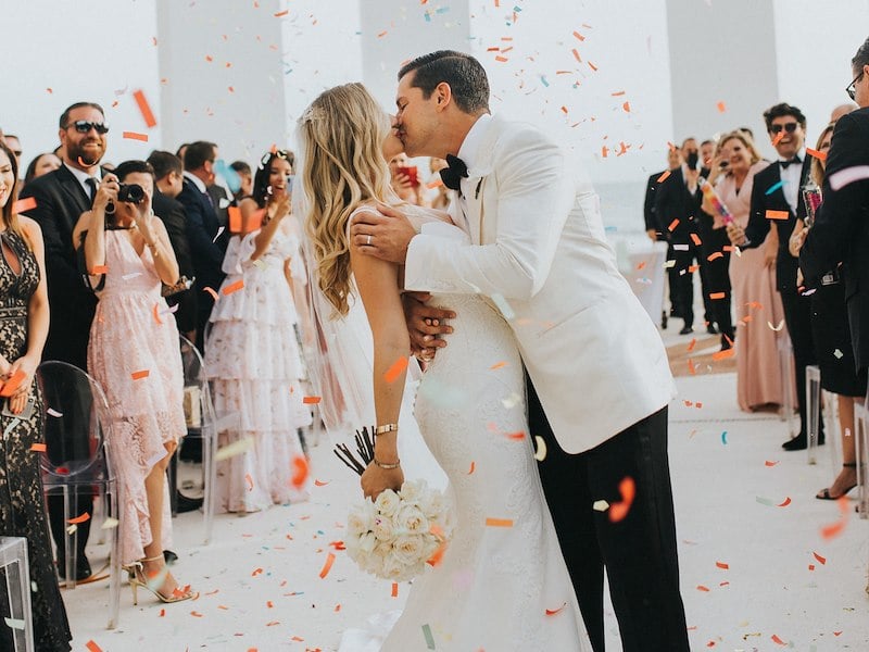 Just married couple kissing at the altar